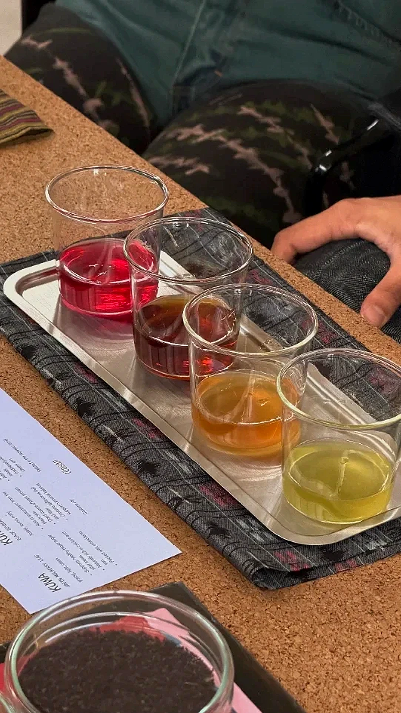 A tasting flight of caffeine-free Japanese teas set out in small cups at a Teasan event